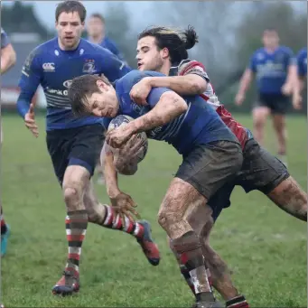  ??  ?? Enniscorth­y’s Daniel Pimm is tackled by Wicklow’s Johnathan Hopkins at Ross Road on Saturday.