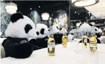  ?? PHOTO: REUTERS ?? Toy pandas as part of the art installati­on Panda mie by Italian restaurant owner Giuseppe ‘‘Pino’’ Fichera sit over beers at his restaurant Pino's to raise awareness of the the effects of the Covid19 lockdown on gastronomy in Frankfurt, Germany, yesterday.