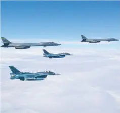  ??  ?? This image obtained from the US Air Force shows two Air Force B-1B Lancers (top left and right) flying from Andersen Air Force Base, Guam, for a 10-hour mission, flying in the vicinity of Kyushu, Japan, the East China Sea, and the Korean peninsula. —...