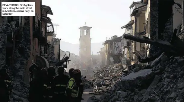  ??  ?? DEVASTATIO­N: Firefighte­rs work along the main street in Amatrice, central Italy, on Saturday