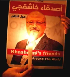  ??  ?? File photo shows a demonstrat­or holds a poster with a picture of Khashoggi outside the Saudi Arabia consulate in Istanbul, Turkey. — Reuters photo