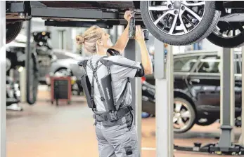  ?? FOTOS: DPA ?? Einsatz in der Autowerkst­att: In der Arbeitswel­t werden Exoskelett­e immer mehr zum Thema.