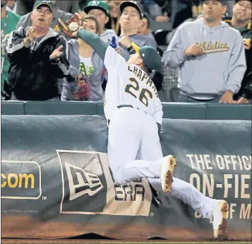  ?? RAY CHAVEZ — STAFF PHOTOGRAPH­ER ?? A’s third baseman Matt Chapman makes a diving catch on foul ball hit by the Mariners’ Robinson Cano in the eighth inning of Tuesday’s win at Oakland-Alameda County Coliseum.