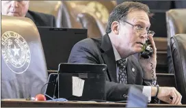  ?? RODOLFO GONZALEZ / AMERICAN-STATESMAN ?? House Rep. John Zerwas, R- Richmond, a sponsor of House Bill 1000, works from his desk on the House floor at the Capitol on Thursday. The bill includes a provision that establishe­s a Core Research Support Fund to promote“increased research capacity”at...