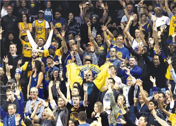  ?? Photos by Carlos Avila Gonzalez / The Chronicle ?? The fans show some love during a timeout in the second half of Friday’s Warriors-Trail Blazers preseason game. The Warriors triumphed after a shaky start.