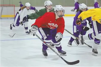  ?? STAFF PHOTO BY MATT WEST ?? CAPTAIN OF THE WOLFPACK: Boston Latin senior captain Rachel Tassinari skates through some drills with her teammates during practice on Tuesday.