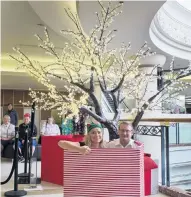  ?? PHOTO: GERARD O’BRIEN ?? Gifting continues . . . Meridian Mall marketing manager Stacey Menzies and Captain David McEwen, of the Salvation Army Dunedin City Corps sit beside a new Tree of Light charitable gifting tree upstairs at the mall yesterday.