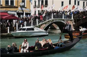  ?? (Manuel Silvestri/Reuters) ?? PEOPLE PROTEST in Venice yesterday against the introducti­on of the registrati­on and tourist fee to visit the city.