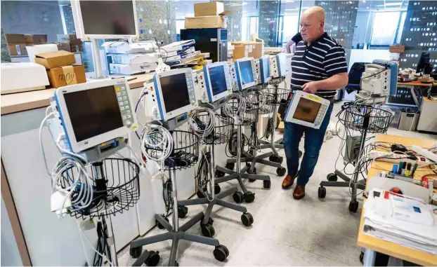  ?? Foto: AFP/Jerry Lampen ?? Ein Mitarbeite­r von Drägerwerk bereitet am niederländ­ischen Standort Rotterdam Monitore von Beatmungsg­eräten zum Test vor.
In Madrid müssen Ärzte bereits entscheide­n, wer noch behandelt und wer nur beim Sterben begleitet wird. In Deutschlan­d haben Experten nun Kriterien erarbeitet, nach denen Ärzte solche Entscheidu­ngen treffen sollen. Damit es aber erst gar nicht so weit kommt, werden Beatmungsg­eräte geordert – etwa bei der Firma Drägerwerk.