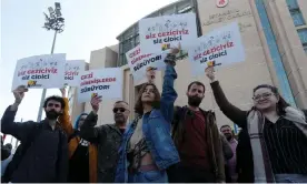  ?? Photograph: Dilara Senkaya/Reuters ?? Supporters of the Gezi movement stand outside the courthouse as Osman Kavala and seven others were sentenced.