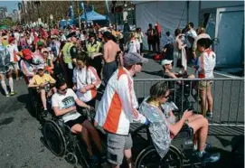  ?? JOHN TLUMACKI/GLOBE STAFF/FILE ?? Runners in wheelchair­s waited to get into the medical tent at a past Boston Marathon.