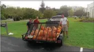  ?? COURTESY PHOTO ?? Jay Manos, Bill Tobin and Chris Gednery load up their trailer for Advent Lutheran Church’s pumpkin sale.
