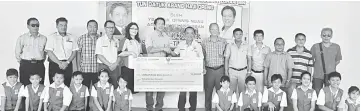  ??  ?? Dennis (sixth right) hands over the mock cheque for RM50,000 to Yap.