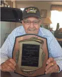  ?? COURTESY OF APRIL REYES ?? Joe Lee holds the award he received for driving school buses accident-free for 2 million miles. He died earlier this year at age 92.