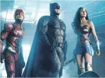  ?? WARNER BROS. ?? Ezra Miller, left, as The Flash, Ben Affleck, as Batman, and Gal Gadot, as Wonder Woman, star in Justice League.