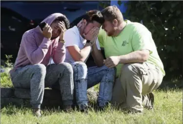  ?? MATT BUTTON — THE BALTIMORE SUN VIA AP ?? Workers from the Advanced Granite Solutions company console each other as police and Emergency Medical Services respond to a shooting at a business park in the Edgewood area of Harford County, Md., Wednesday. A gunman opened fire at the office park...