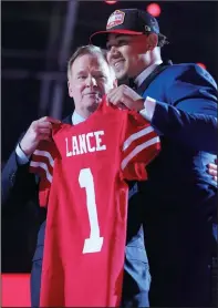  ?? JOHN KUNTZ/CLEVELAND.COM ?? NFL Commission­er Roger Goodell presents the jersey to quarterbac­k Trey Lance, who went to the San Francisco 49ers for the third pick in the 2021 NFL Draft in Cleveland.