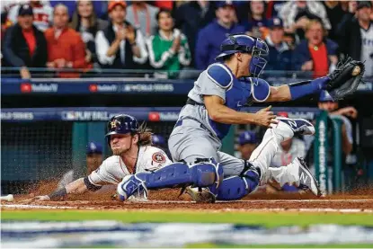  ?? Karen Warren / Houston Chronicle ?? Josh Reddick’s dramatic head-first slide across the plate after an Evan Gattis single in the fifth capped the Astros’ scoring in Game 3, and the bullpen held on for a 5-3 victory and a 2-1 lead in the series. Complete coverage of Game 3 starts on page C1.