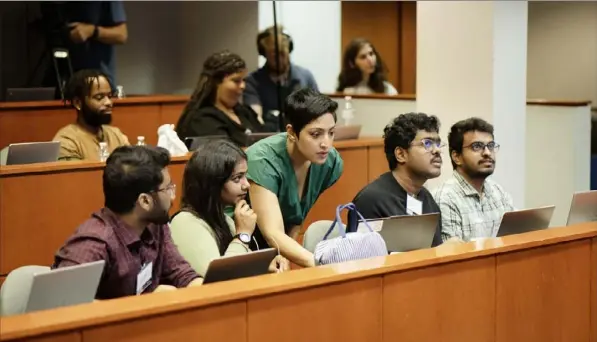  ?? Marvin Joseph/The Washington Post ?? Rumman Chowdhury, center, at the red-teaming event at Howard University in July. The event drew AI enthusiast­s from the Washington, D.C., area.