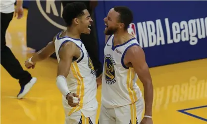  ??  ?? Stephen Curry, right, celebrates with Jordan Poole during the Warriors’ victory over the Grizzlies. Photograph: Jeff Chiu/AP