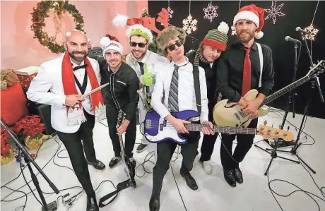  ?? MIKE DE SISTI / MILWAUKEE JOURNAL SENTINEL ?? Local ska band Something to Do’s musically upbeat, lyrically depressing song “Happy Holidays” was partially inspired by frontman Nate Tredinnick being unemployed during the holidays. The band is Brad Klotz (from left), Chris Holoyda, Chris Smith,...