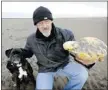  ?? Getty Images ?? Ken Wilman and a yellowish stone — a rare form of whale vomit, or ambergris. He has been offered $65,000 for this strange-smelling
rock his dog found on a beach