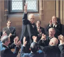  ?? Focus Features ?? GARY OLDMAN, center, portrays Winston Churchill as the English politician advances to prime minister early in WWII.