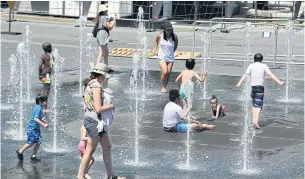  ?? AFP ?? Women and children play in the water fountains at the Place des Arts in Montreal on Tuesday as high summer temperatur­es scorched eastern Canada this week.