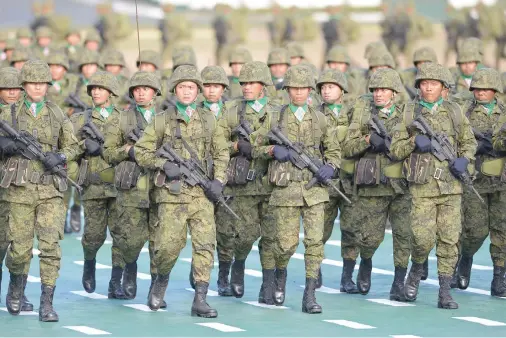  ??  ?? Philippine soldiers marching during the army’s 120th anniversar­y ceremony at Fort Bonifacio camp in Manila on Tuesday. President Rodrigo Duterte attended the event. (AFP)