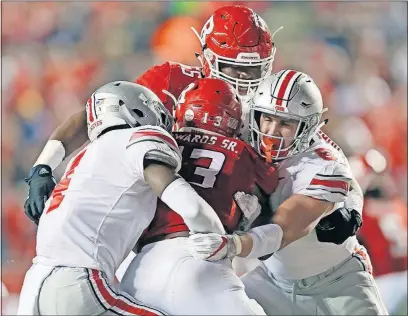  ?? [KYLE ROBERTSON/DISPATCH] ?? Ohio State’s Jordan Fuller, left, and Sam Hubbard stop Rutgers running back Gus Edwards during the first half.