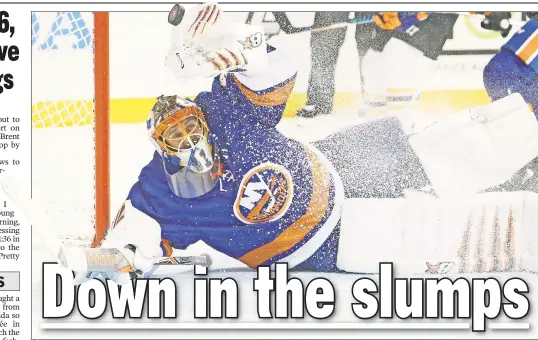  ?? Paul J. Bereswill; Getty Images ?? ALL TRIPPED UP: Jaroslav Halak is unable to stop a Tim Schaller goal during the third period of the struggling Islanders’ 5-1 loss to the Bruins on Tuesday night. Jason Chimera (below) gets tangled up with goalie Tuuka Rask during the first period.