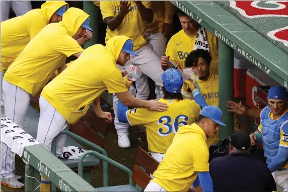  ?? MARY SCHWALM — THE ASSOCIATED PRESS ?? Red Sox first baseman Triston Casas is congratula­ted in the dugout after hitting a three-run home run during a game against the Orioles on Sunday, Sept. 10, 2023in Boston. The players were wearing the popular yellow City Connect uniforms.