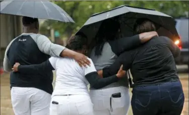  ?? GERALD HERBERT — THE ASSOCIATED PRESS ?? Cameron Sterling, left, son of Alton Sterling, hugs family members after they spoke to reporters following a meeting with the U.S. Justice Department at federal court in Baton Rouge, La., Wednesday. The Justice Department has decided not to charge two...