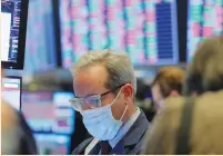  ?? (Lucas Jackson/Reuters) ?? A trader wears a mask as he works on the floor of the New York Stock Exchange (NYSE) as the building prepares to close indefinite­ly due to the coronaviru­s disease (COVID-19) outbreak last week in New York.