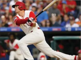  ?? LAURENCE KESTERSON — THE ASSOCIATED PRESS ?? Phillies left fielder Rhys Hoskins follows through on a two-run home run Saturday night against the Cubs at Citizens Bank Park in the first inning