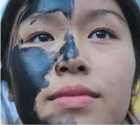  ?? DARRYL DYCK/ THE CANADIAN PRESS ?? A protester wears face paint at a Vancouver rally opposing the Northern Gateway pipeline recently. Columnist Terry Glavin expects Canadians to realize by October 2015 that the Tories have made promises on the environmen­t that they never intended to keep.