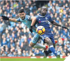  ??  ?? Sergio Aguero tries to get the better of Chelsea’s Victor Moses.