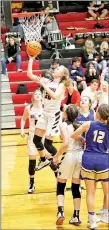  ?? Photograph­s courtesy of Russ Wilson ?? Junior Lady Blackhawk Blakelee Winn (No. 22) goes for the goal Tuesday, Jan. 28, at home against Harrison.