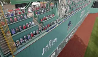  ?? Stuart CahIll / herald StaFF FIle ?? NOT THE SAME: The Green Monster is full of cutout fans as the Red Sox take on the Orioles on Opening Day at Fenway Park on July 24, 2020.