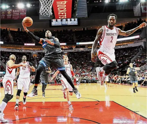  ?? — AP ?? Not that way: Orlando Magic guard C. J. Watson shoots past Houston Rockets guard Patrick Beverley (right) in the NBA game in Houston on Tuesday.