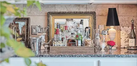  ??  ?? Below: A beautifull­y styled bar is always at the ready in the kitchen, so guests can help themselves.