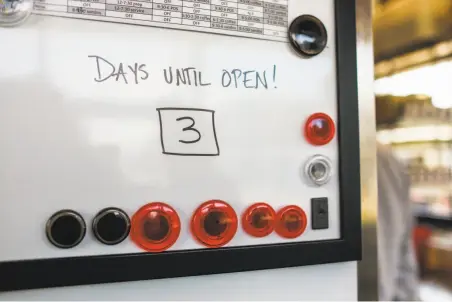  ?? Photos by Gabrielle Lurie / The Chronicle ?? A white board at the Bi-Rite cafe announces that three days are left before the establishm­ent opens.