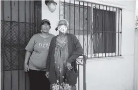  ?? PEDRO PORTAL pportal@miamiheral­d.com ?? Sharon Frazier-Stephens and her mother, Louella Wallace, outside their two-bedroom duplex in Little Haiti. The home has been upgraded with a new roof and impact windows.