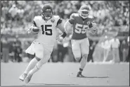  ?? AP/PHELAN M. EBENHACK ?? Jacksonvil­le Jaguars quarterbac­k Gardner Minshew III (15) scrambles for yardage past Kansas City Chiefs defensive end Frank Clark (55) during the first half Sunday in Jacksonvil­le, Fla.