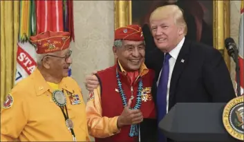  ?? AP PHOTO/SUSAN WALSH ?? President Donald Trump, (right) meets with Navajo Code Talkers Peter MacDonald, center, and Thomas Begay (left) in the Oval Office of the White House in Washington, Monday.