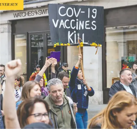  ?? PHIL LEWIS / WENN ?? Thousands of anti-vaccine protesters march through London this month. Their message, and shaky knowledge of science, is finding new ears.