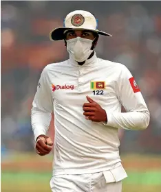  ?? AP ?? Sri Lanka captain Dinesh Chandimal fields wearing an anti-pollution mask during a test match in New Delhi late last year.