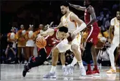  ?? WADE PAYNE — THE ASSOCIATED PRESS ?? Alabama guard Jahvon Quinerly (5) collides with Tennessee forward Olivier Nkamhoua (13) during the first half Wednesday in Knoxville, Tenn.