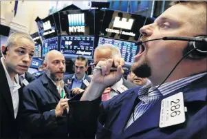  ?? AP PHOTO ?? In this June 23, 2017, file photo, trader Michael Milano, right, works in the crowd during the Russell rebalance on the floor of the New York Stock Exchange at the close of trading.