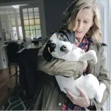  ?? STEVEN SENNE/ THE ASSOCIATED PRESS ?? Kate Fredette with Roscoe, who the family adopted after being matched through How I Met My Dog.